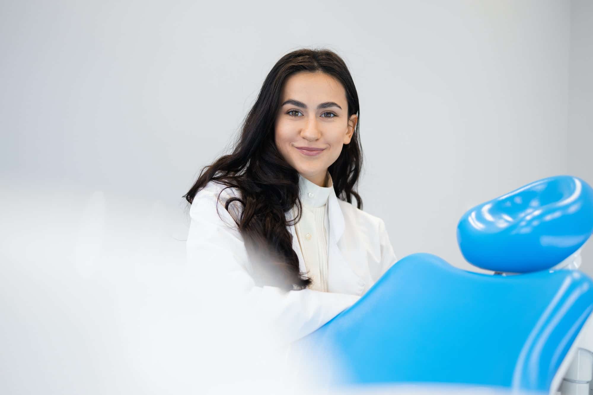 Portrait of young female dentist in office