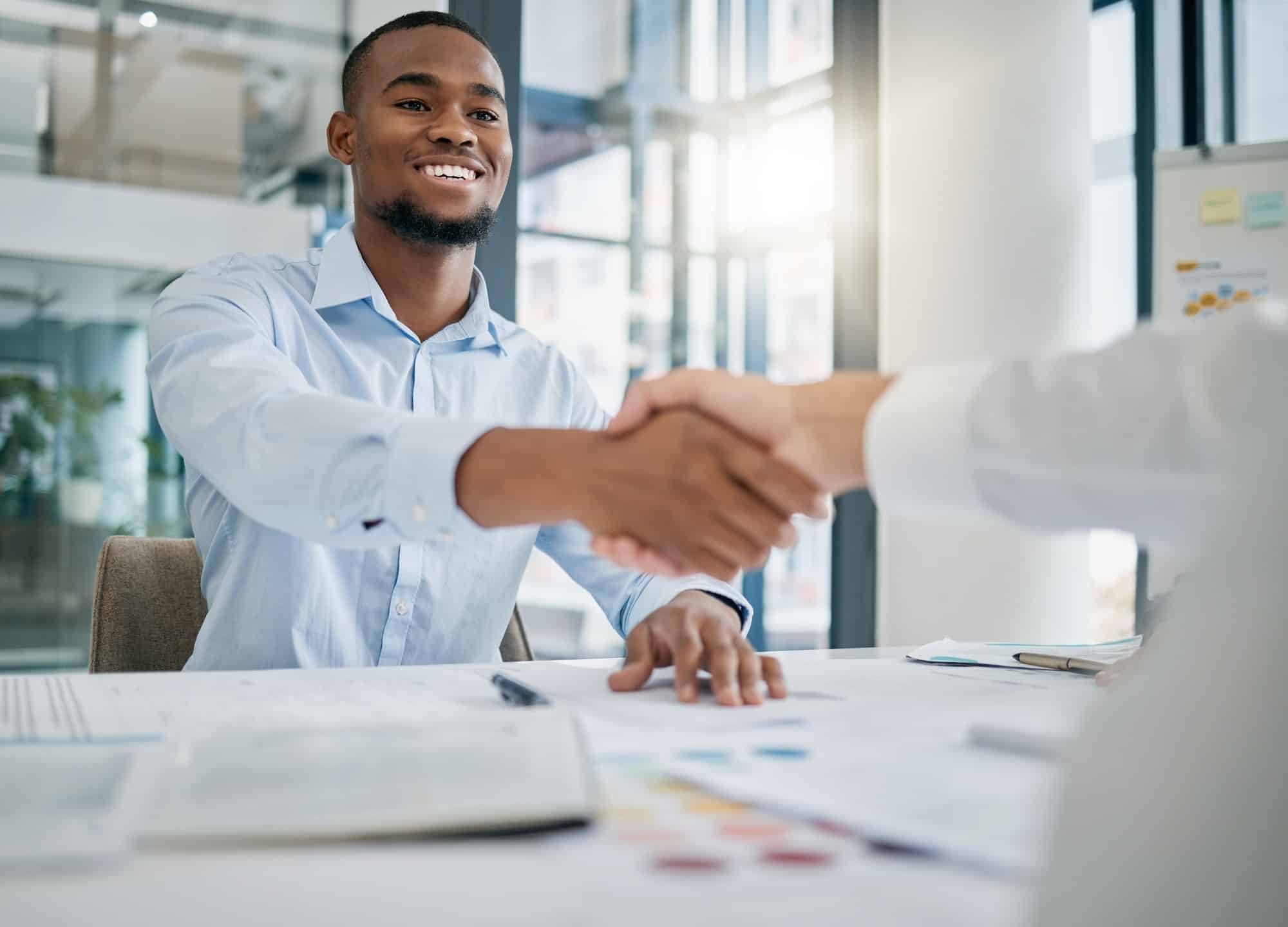 Hiring, designer or black man shaking hands with human resources manager for a successful job inter