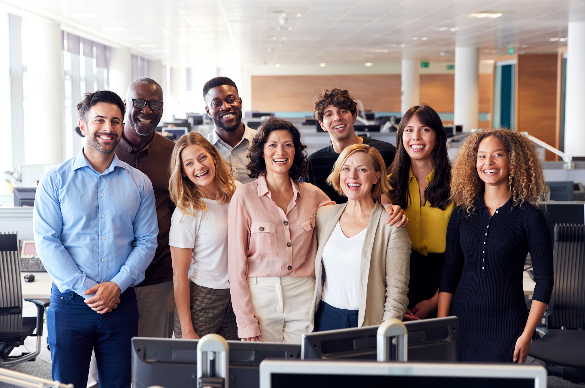 Portrait Of Smiling Business Team Working In Modern Office Together